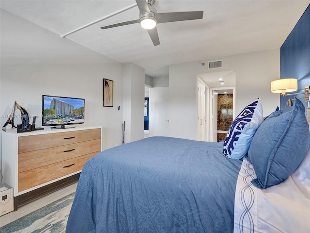 bedroom with ceiling fan and light hardwood / wood-style flooring