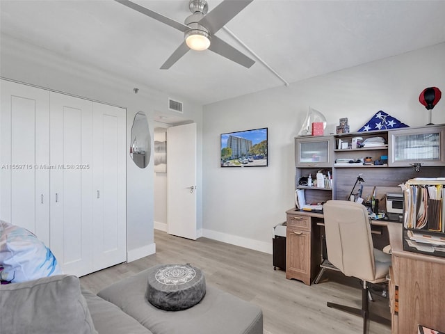 home office featuring ceiling fan and light hardwood / wood-style floors