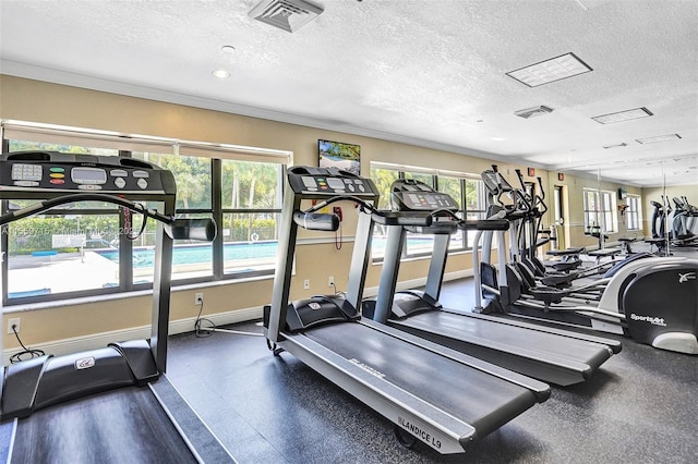 exercise room featuring a healthy amount of sunlight and a textured ceiling