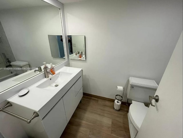 bathroom featuring hardwood / wood-style flooring, vanity, and toilet