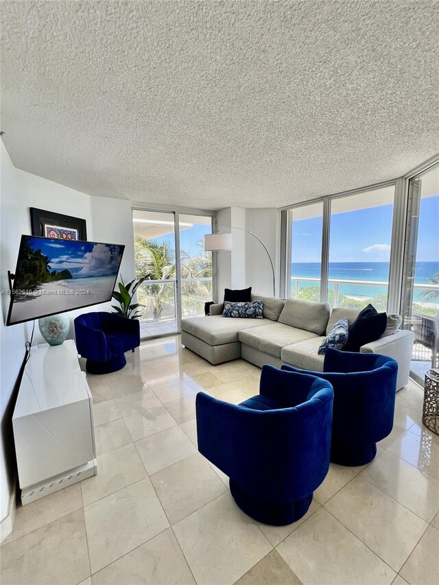 living room with a wall of windows and a textured ceiling