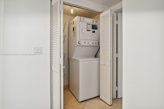 washroom with light tile patterned floors and stacked washer and clothes dryer