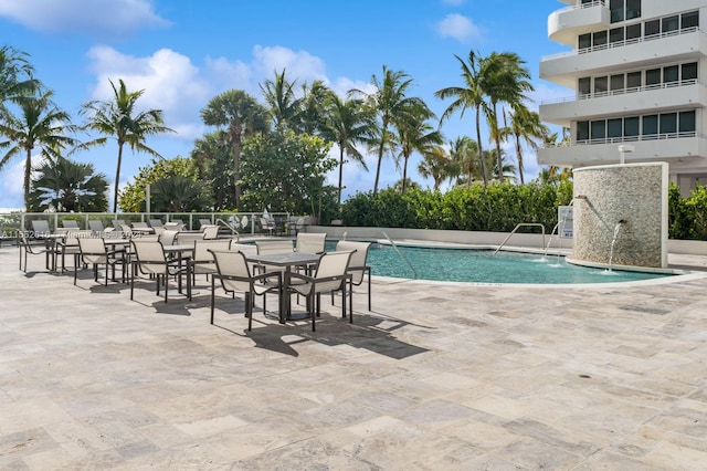 view of pool with a patio area and pool water feature