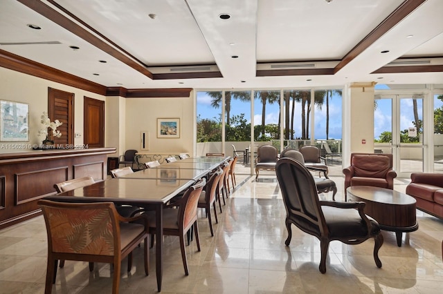 dining space featuring french doors, a tray ceiling, light tile patterned floors, and ornamental molding