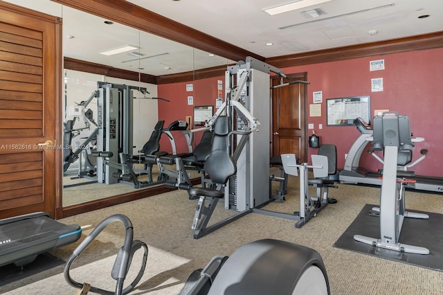 gym featuring crown molding and carpet flooring