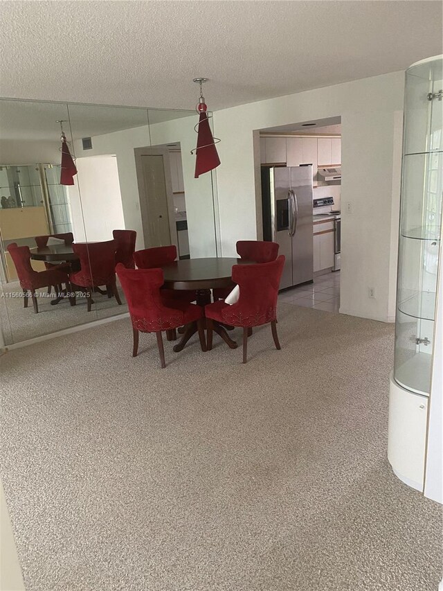 spare room featuring carpet flooring and a textured ceiling