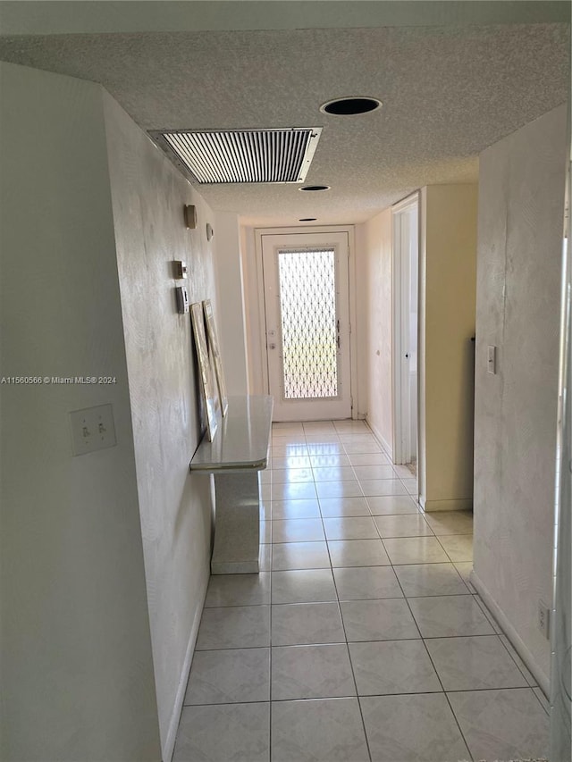 hallway with light tile patterned flooring