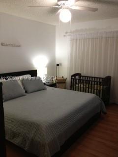 bedroom featuring dark hardwood / wood-style floors and ceiling fan