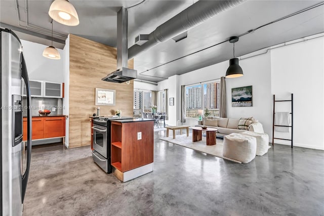 kitchen with appliances with stainless steel finishes, wooden walls, and hanging light fixtures