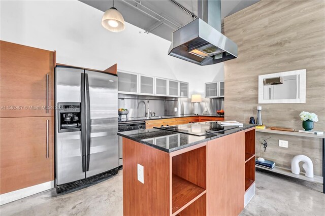 kitchen featuring a center island, wooden walls, decorative light fixtures, island exhaust hood, and stainless steel refrigerator with ice dispenser