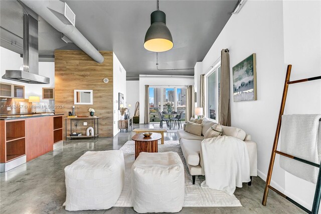 living room with concrete floors and wood walls