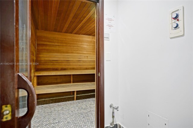 view of sauna / steam room with wood ceiling and tile patterned flooring