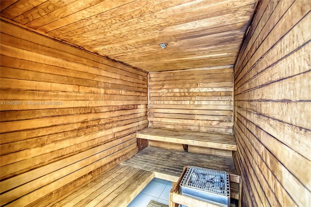 view of sauna with wooden walls and wood ceiling