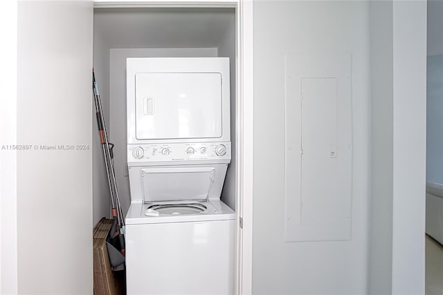 laundry area featuring stacked washer / drying machine