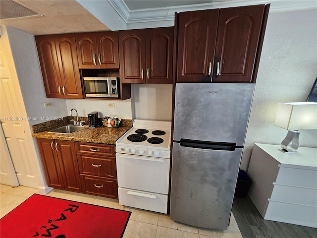 full bathroom with toilet, tiled shower / bath, vanity, and tile walls