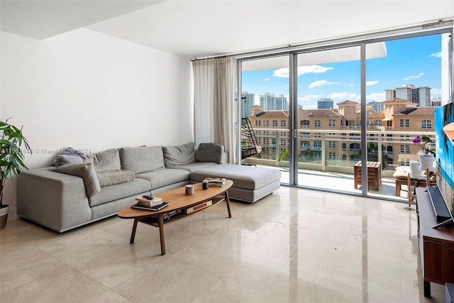 tiled living room featuring floor to ceiling windows