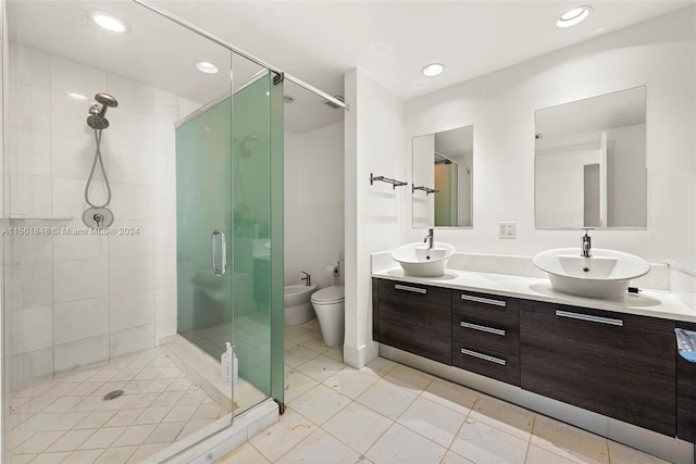 bathroom featuring tile floors, a bidet, double sink, a shower with door, and vanity with extensive cabinet space