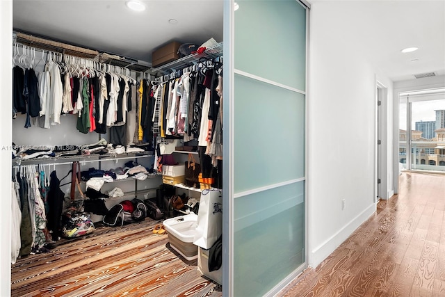 walk in closet with light wood-type flooring