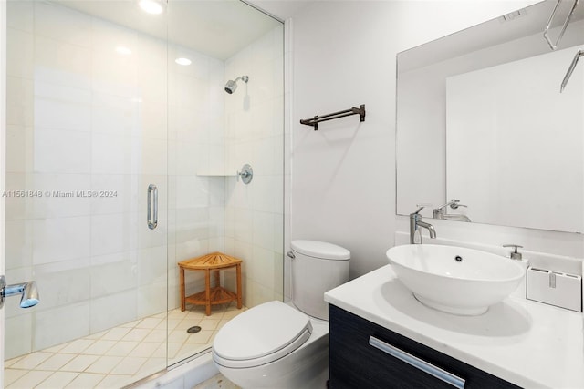 bathroom featuring toilet, an enclosed shower, and vanity