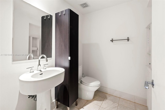 bathroom with tile flooring and toilet