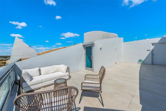 view of patio featuring a balcony and an outdoor hangout area