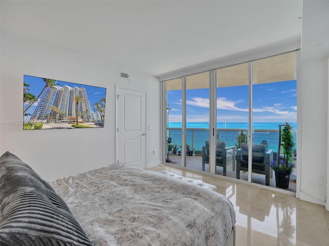 tiled bedroom featuring a water view, access to exterior, and expansive windows