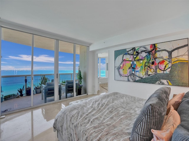 bedroom featuring a water view, light tile floors, and access to outside