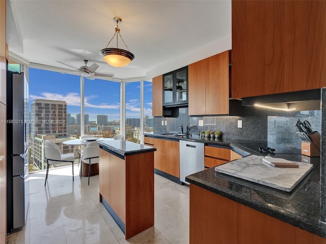 kitchen with ceiling fan, a kitchen island, backsplash, hanging light fixtures, and white dishwasher