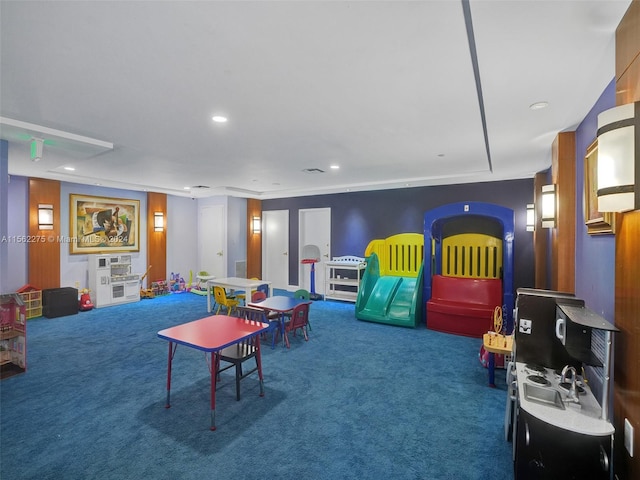 playroom featuring dark colored carpet