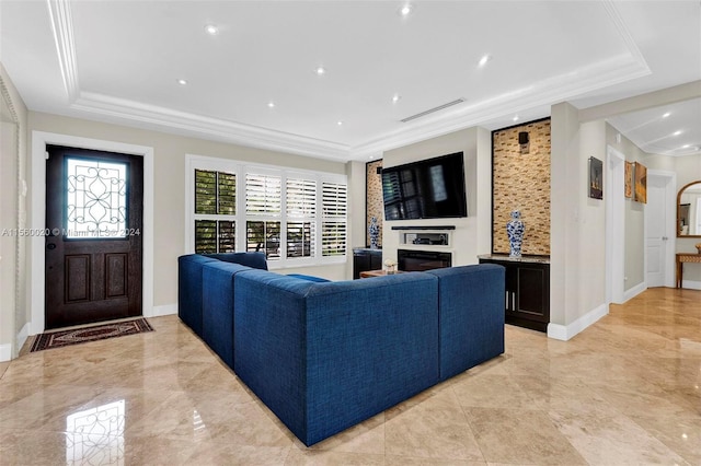 living room featuring a tray ceiling and light tile floors