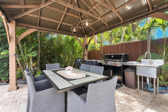 view of terrace featuring an outdoor bar, a gazebo, and area for grilling