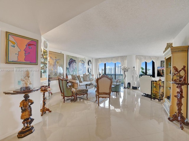 living room featuring tile flooring and a textured ceiling