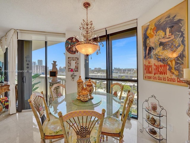 tiled dining space featuring a notable chandelier, a textured ceiling, and a wall of windows