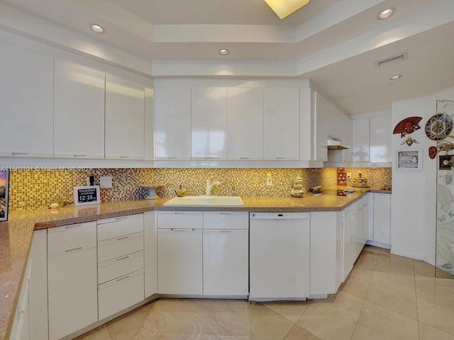 kitchen featuring sink, tasteful backsplash, dishwasher, and light tile floors