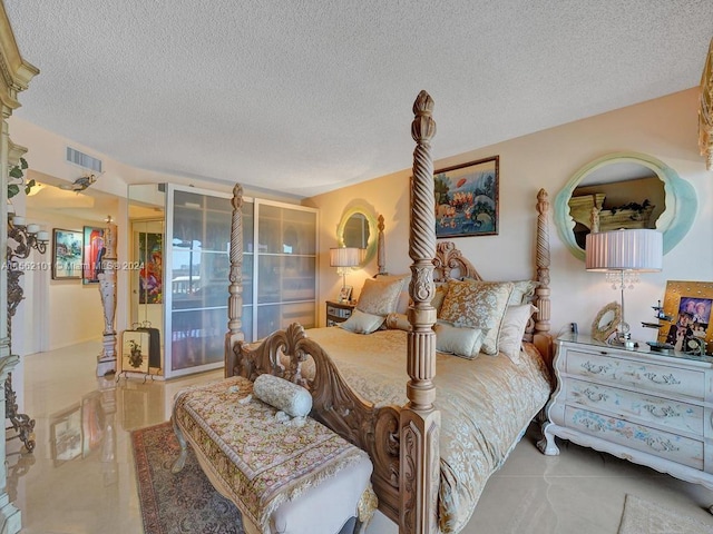 bedroom featuring tile floors and a textured ceiling