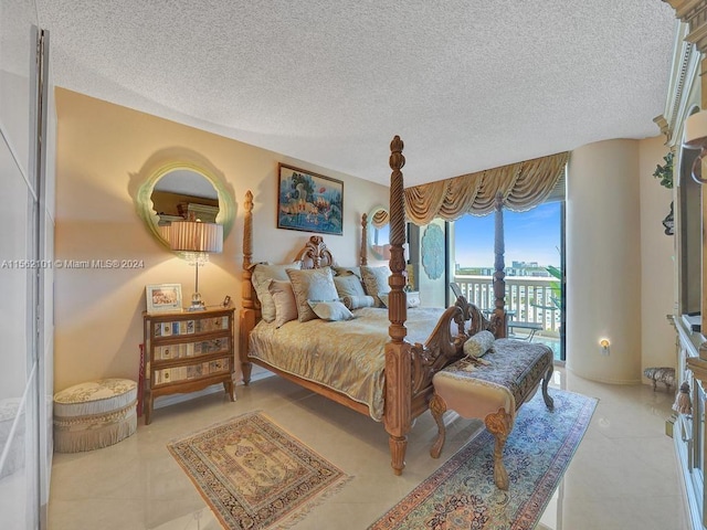 tiled bedroom featuring access to exterior and a textured ceiling