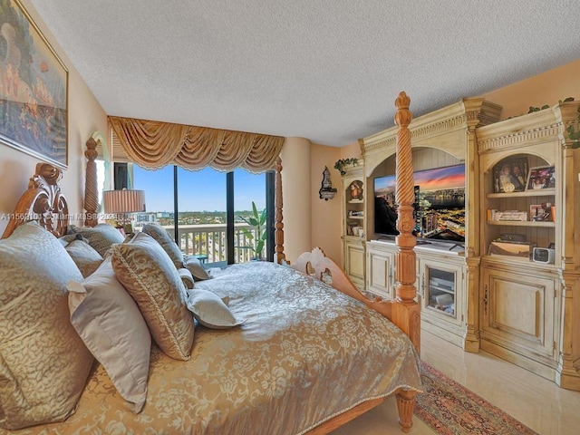 tiled bedroom featuring a textured ceiling and access to exterior