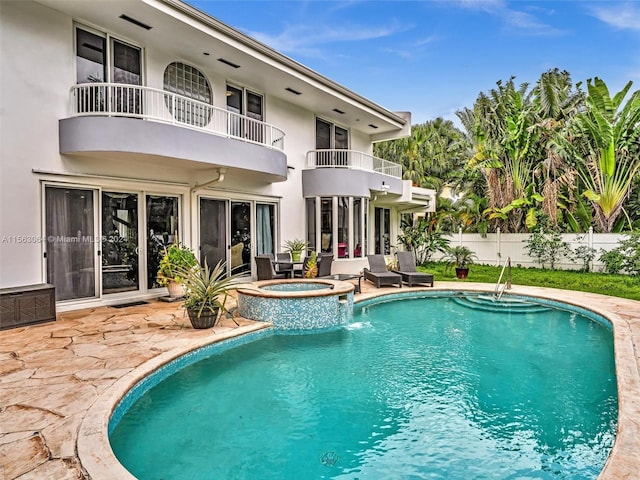 view of pool with an in ground hot tub and a patio