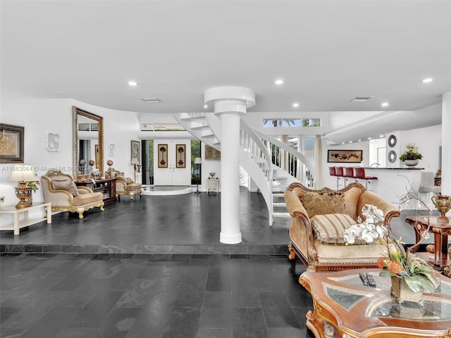 living room with plenty of natural light, dark hardwood / wood-style floors, and ornate columns