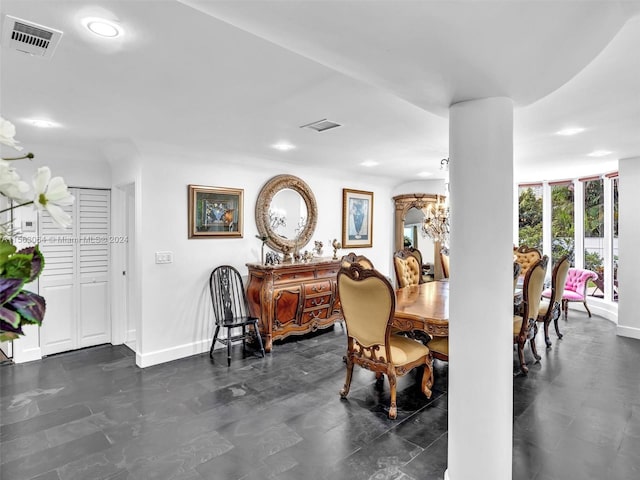 tiled dining room with a chandelier