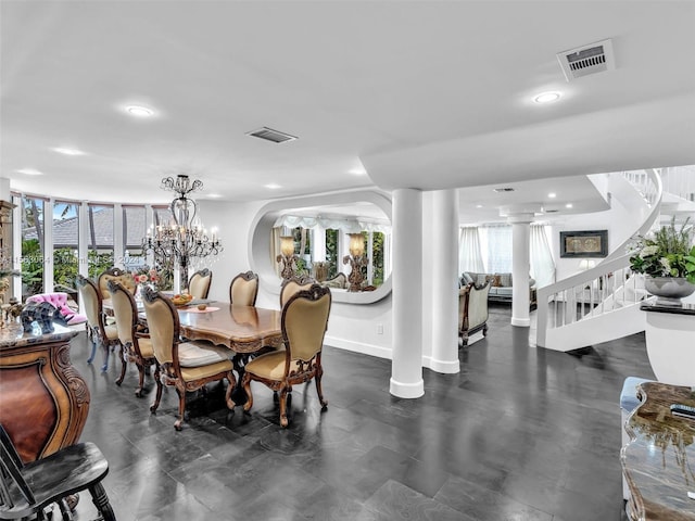 dining room with a chandelier, ornate columns, and a healthy amount of sunlight