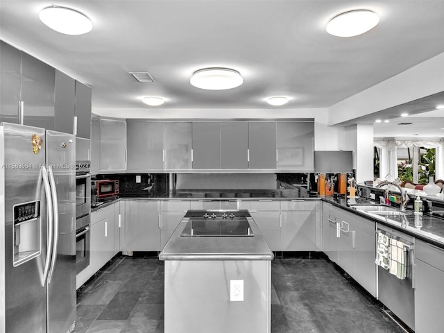 kitchen featuring dark tile floors, black appliances, and sink