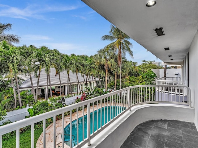 balcony with a fenced in pool