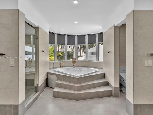 bathroom featuring tile flooring and separate shower and tub