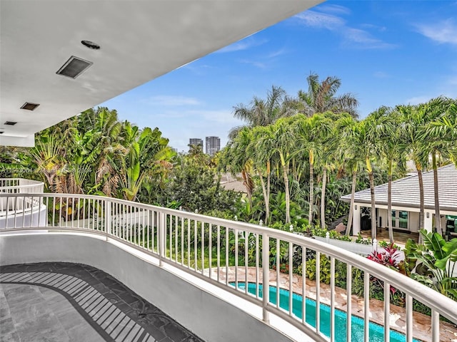 balcony with a fenced in pool