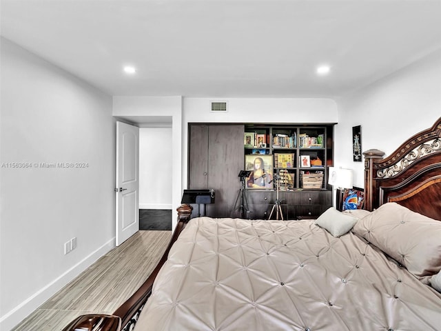 bedroom with hardwood / wood-style floors