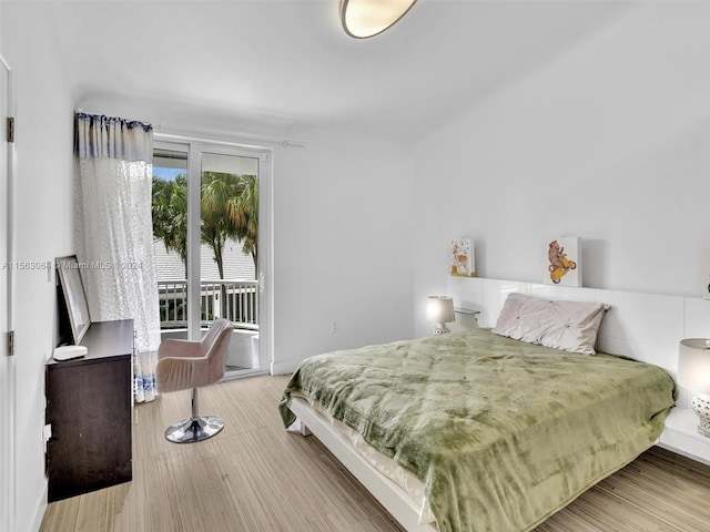 bedroom featuring light hardwood / wood-style floors and access to exterior