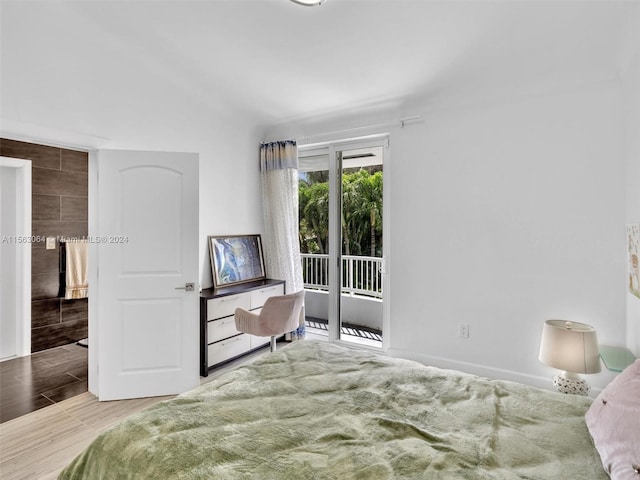 bedroom with access to outside and light wood-type flooring