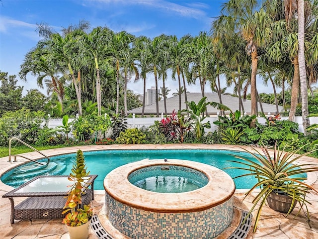 view of swimming pool with a patio and an in ground hot tub