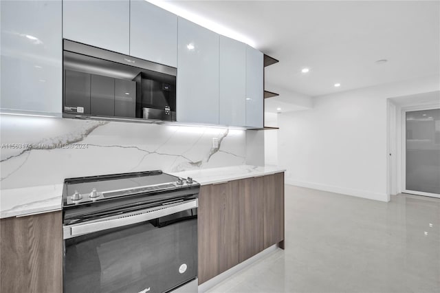 kitchen featuring stainless steel appliances, white cabinetry, and light stone countertops